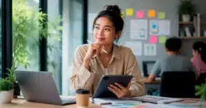 A young professional uses AI tools on a tablet, showing AI careers that rely on creativity and problem solving, not coding.